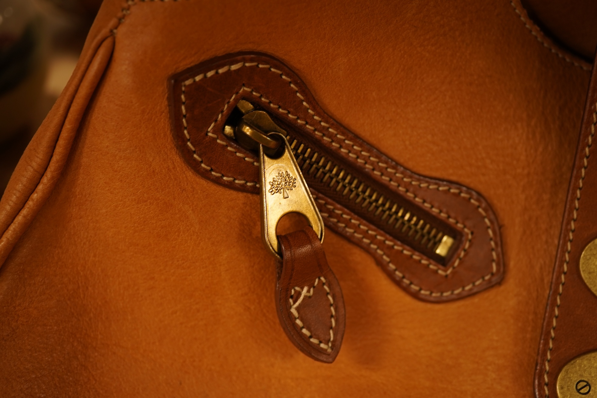 A Mulberry tote two zip, three postman clasps,tan leather with dark brown trim.handbag